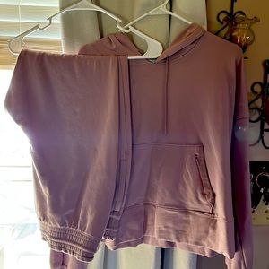 Matching set like pants and a hoodie with a front zipper pocket